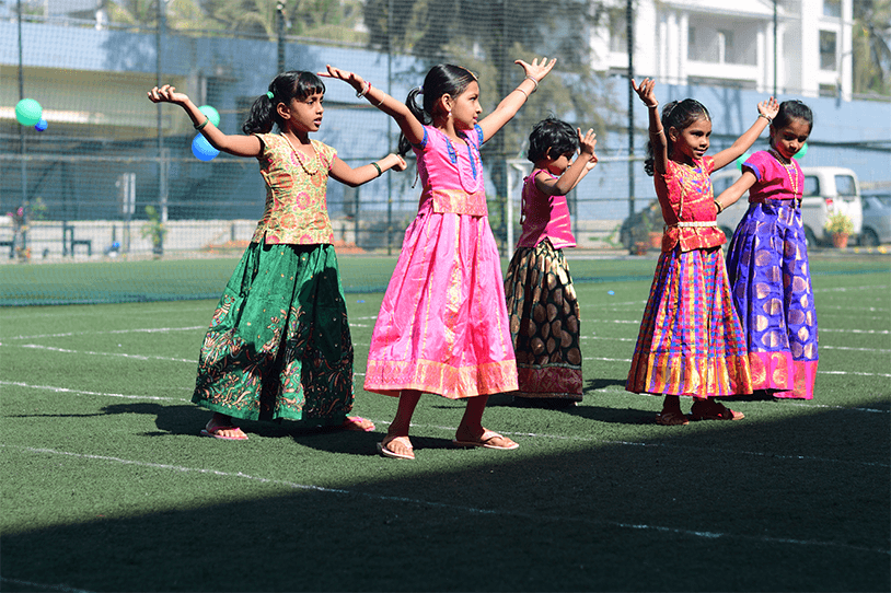 Children performing a cultural dance at Adra