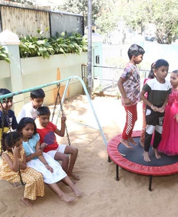 Children playing on the farm and playground at Adra